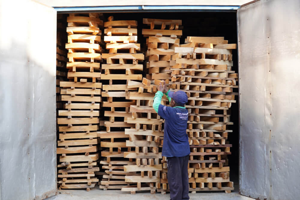 worker arranging wood at furniture factory