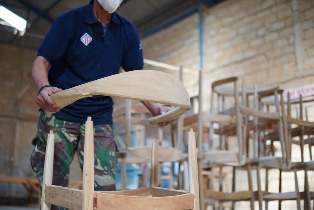 A Worker is assembling chairs at indonesian furniture factory - MPP Furniture