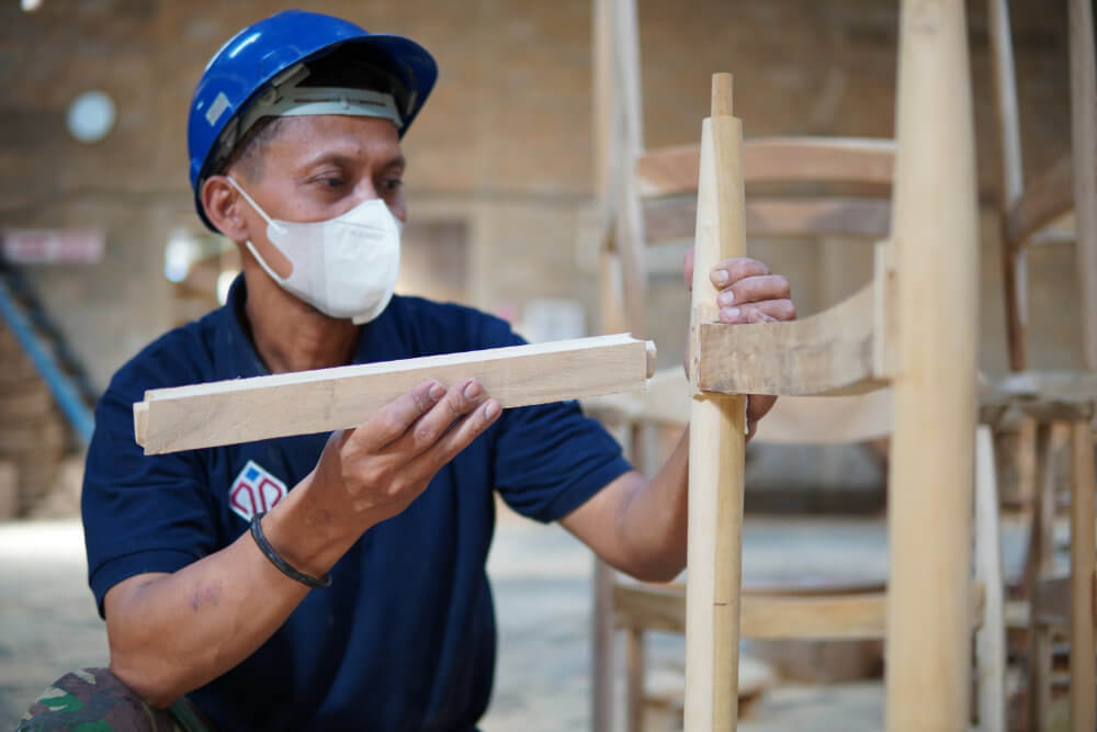 worker assembling chair at factory
