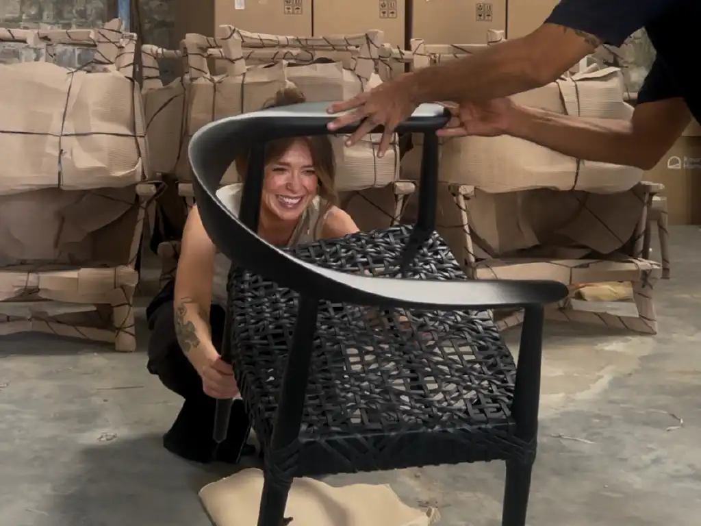 The US buyer inspection a wooden arm chair with leather woven at MPP Furniture-Indonesain Furniture Manufacturer at Cirebon