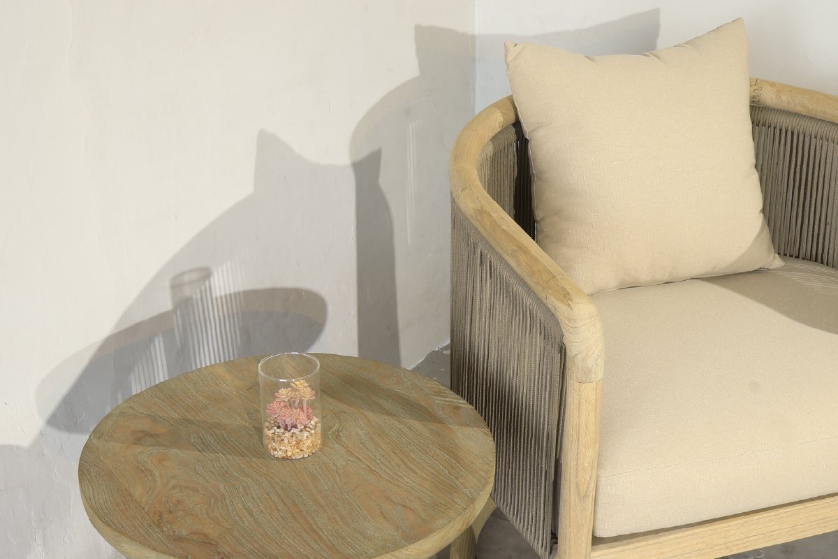 Curved furniture teak wood lounge chair with round side table in minimalist indoor, Indonesian furniture design 2025