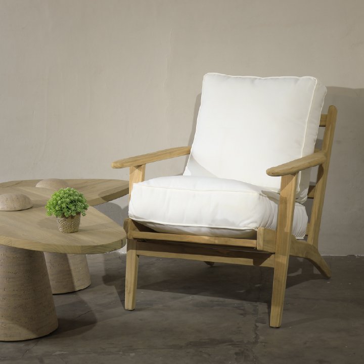 Sungkai wood lounge chair with thick white cushions and sculptural sungkai coffee table, perfect for indoor lounge or boutique hotel use.