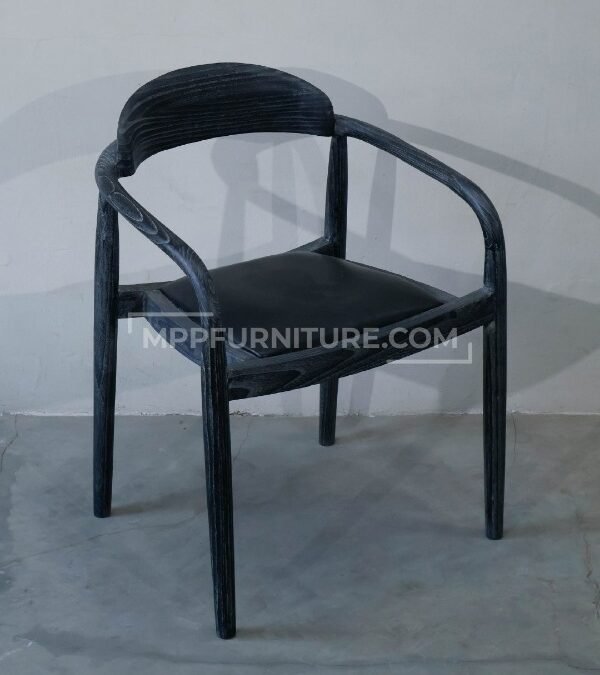 Modern restaurant chair, the Crescent Dining Chair, featuring a custom brushed black wood finish and a durable black leather seat. Made by Custom Furniture Manufacturer MPP Furniture