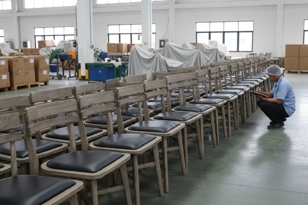 Production line in an Indonesian factory showing multiple identical sideboards with a consistent, controlled Weathered Wood finish