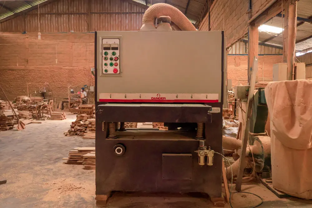 Industrial Wide Belt Sander used for achieving a consistent, high-quality, smooth surface finish on wood, a key machine for an Indonesian furniture manufacturer.