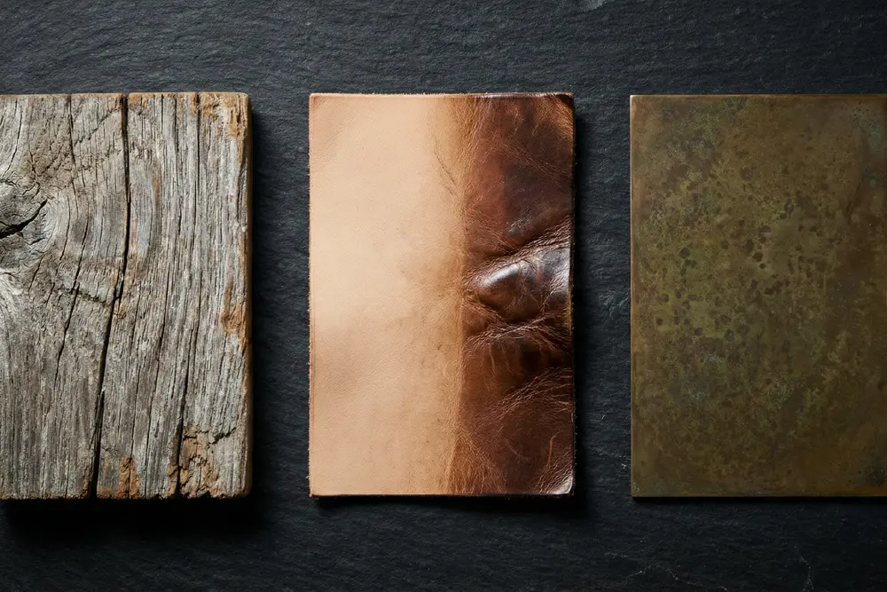 Material science of patina: A comparison of weathered wood, vegetable-tanned leather, and bronze with noble rust, illustrating natural aging processes.