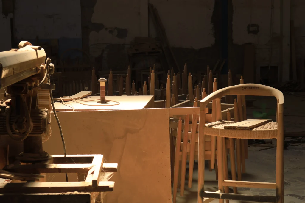 Indonesian furniture manufacturer crafting durable mindi wood for apartments in a dedicated woodworking shop.