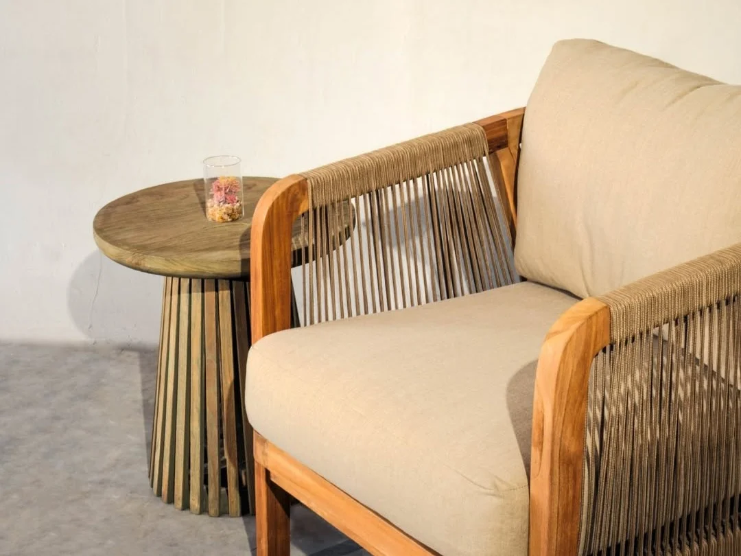 Compact mindi wood for apartments featuring a lightweight woven lounge chair and small side table.