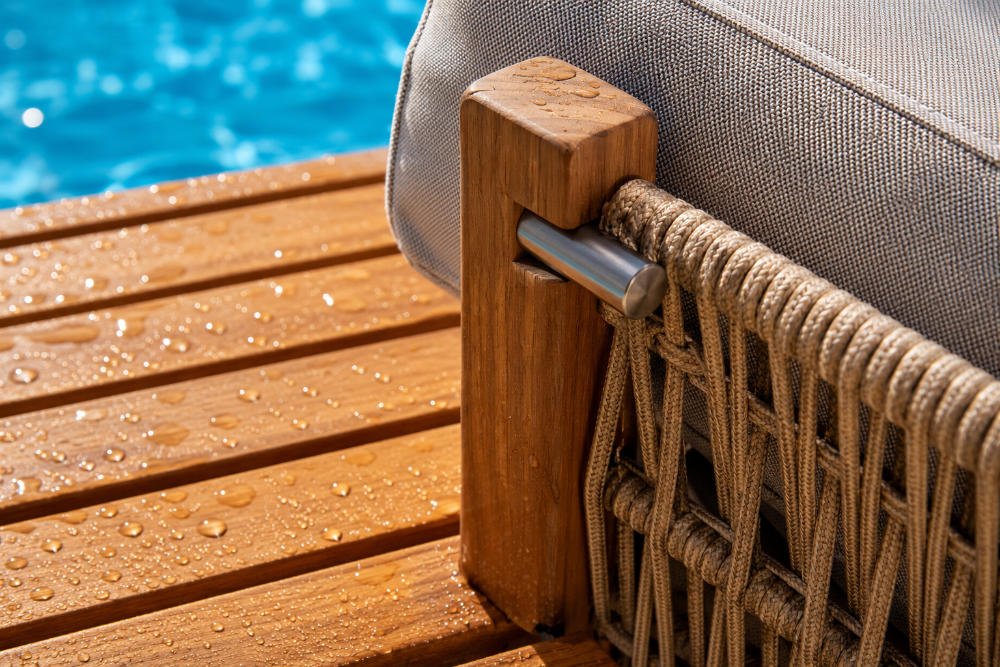 Close up of poolside furniture materials with water resistant teak and outdoor rope