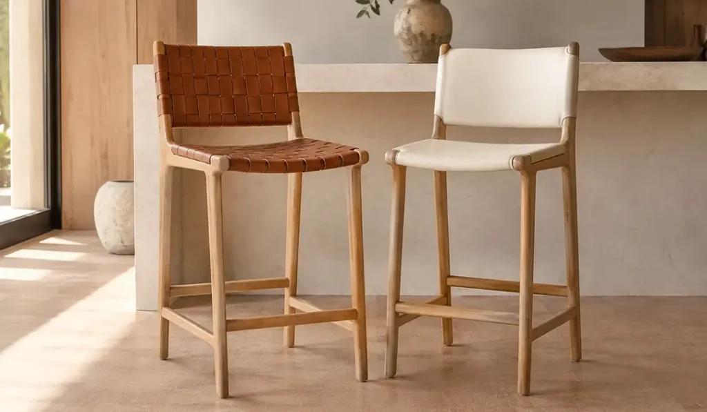 Sungkai wood counter stools with cognac leather seats in a modern indoor furniture collection